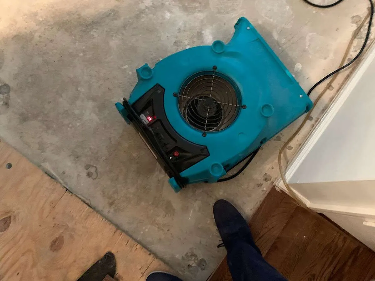 Air mover drying subfloor during Commercial Water Damage Restoration in Dayton